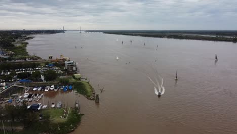 Das-Boot-überquert-Den-Paraná-Fluss-Zwischen-Den-Segelbooten-Mit-Der-Brücke-Und-Den-Inseln-Im-Hintergrund