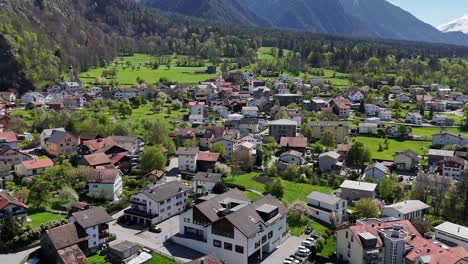 quaint swiss town with green fields in trimmis during sunny day