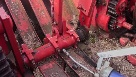 greasing the finger mechanism on an old small square baler