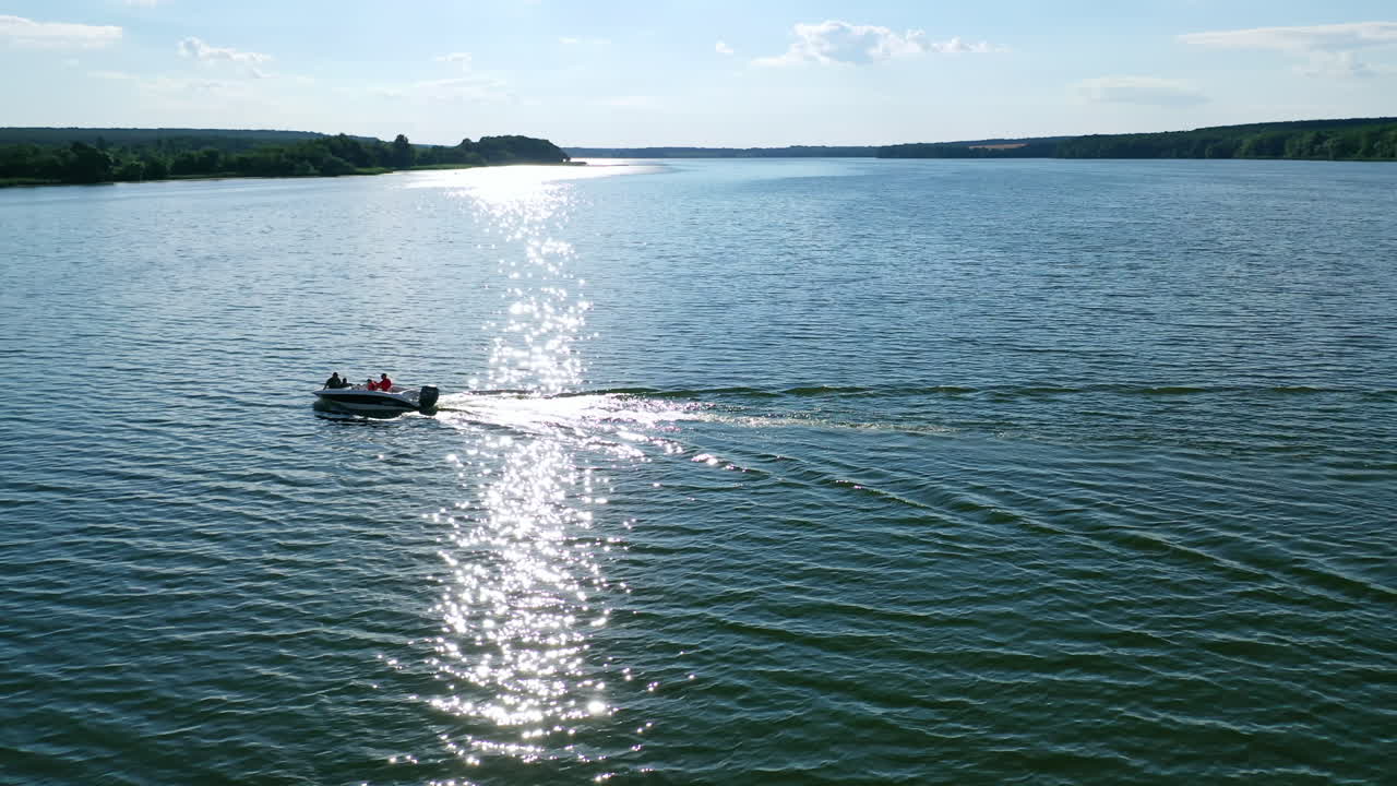 Speed boat on river. Aerial view of landscape of river banks