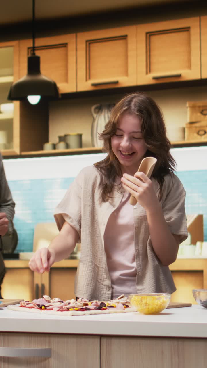 Vertical Video Family cooking time in the kitchen with karaoke and fun dance moves