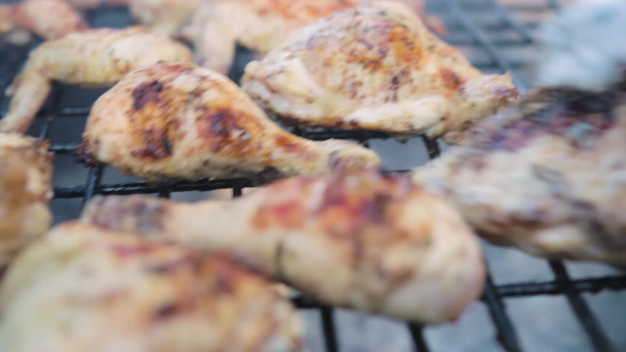 Turning chicken on an open fire