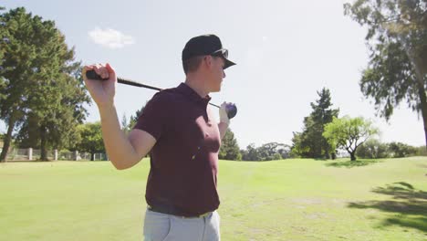 Video-of-happy-caucasian-man-holding-golf-club-on-golf-filed