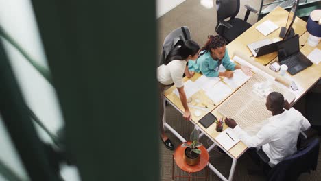 Happy-diverse-architects-looking-at-architectural-models-at-office