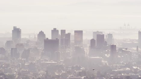 vista general del paisaje urbano con múltiples rascacielos altos y edificios cubiertos de niebla