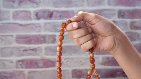 hand holding prayer beads