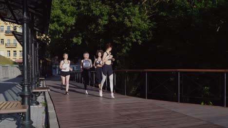 women running in a city park