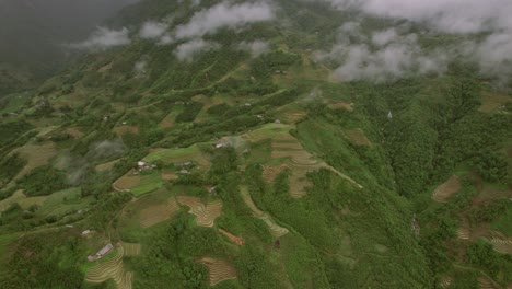 vista aérea de la colina en sa pa, vietnam, con algunos campos de arroz y viviendas, nubes y atmósfera pacífica