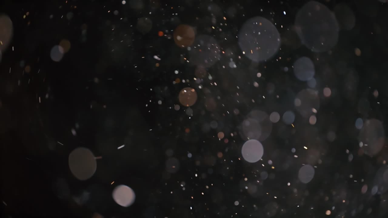 Floating abstract particle bokeh on dark background