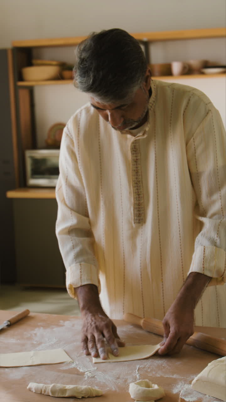 Indian Man Making Flatbread in His Kitchen