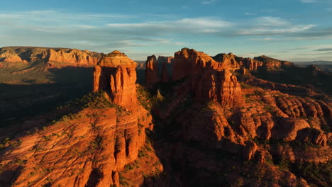 golden sunlight shining over sedona valley in arizona - aerial shot