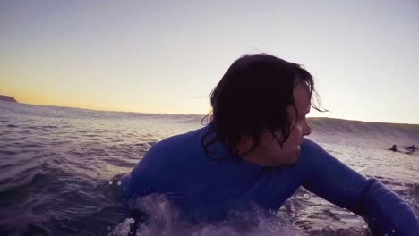 surfer swimming in sea