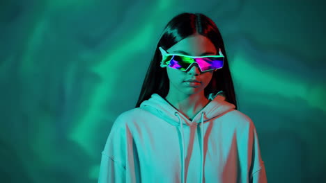 young woman in futuristic glasses with neon lighting
