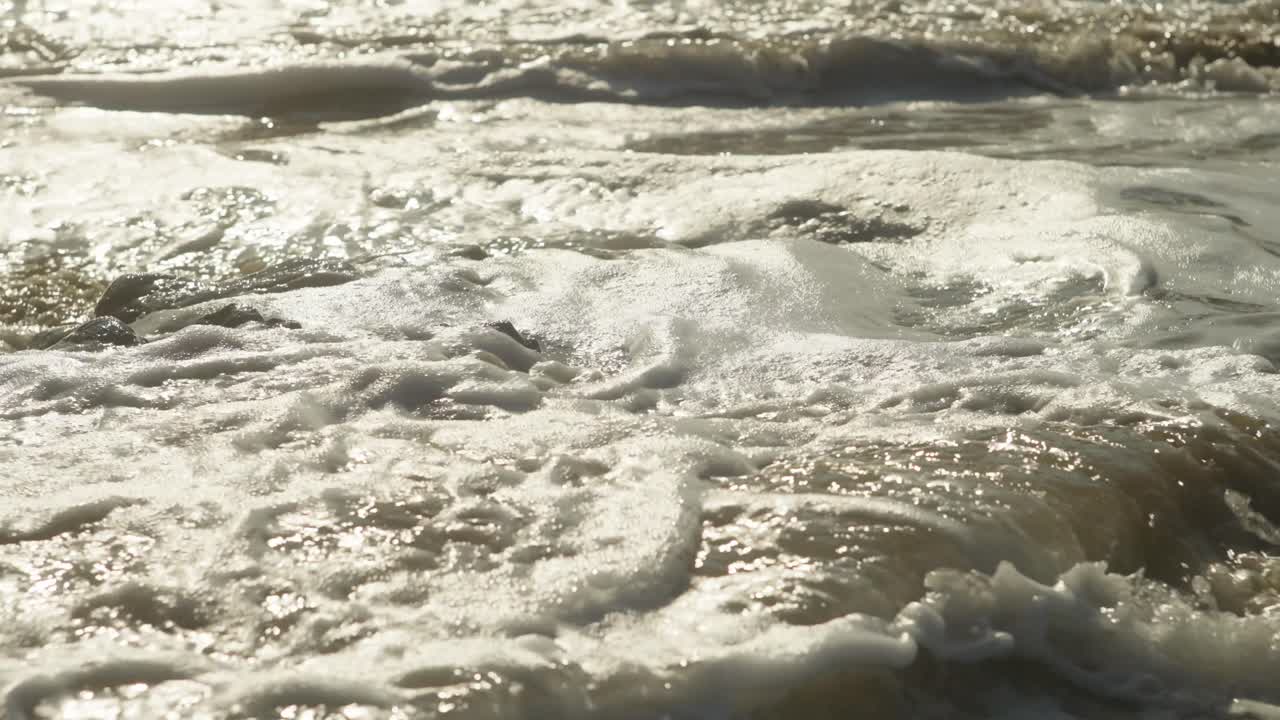 SLOW MOTION CLOSE UP SHOT OF A WAVE CRASHING DOWN ON A ROCK AT THE BEACH OF IXTAPA IN MEXICO