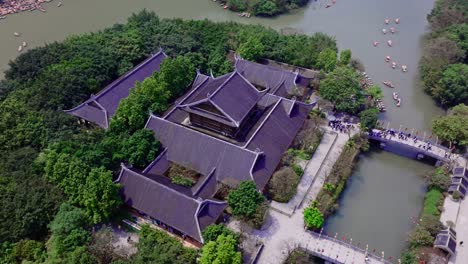 aerial view of a traditional chinese temple on an island