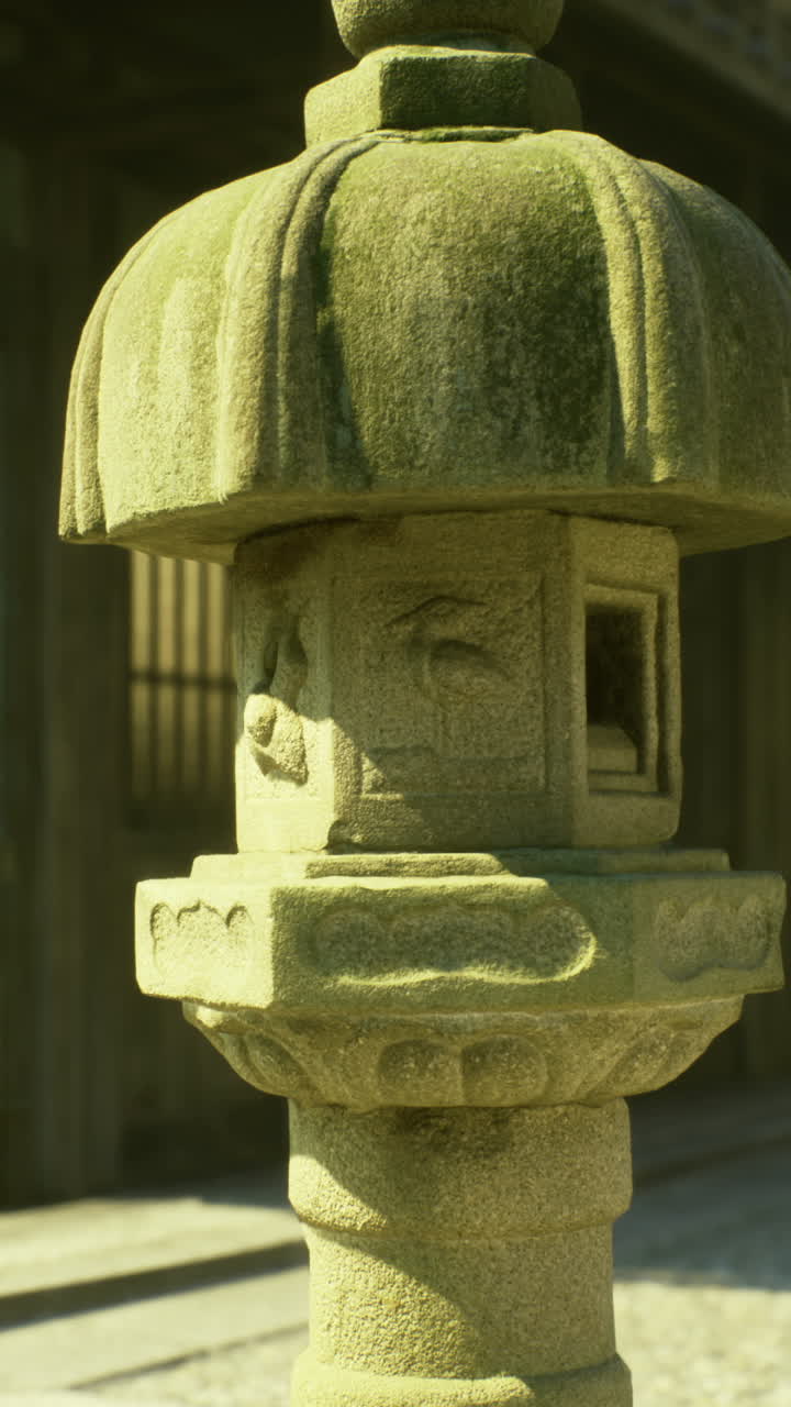 Ancient stone lantern in a traditional japanese garden during sunny daylight