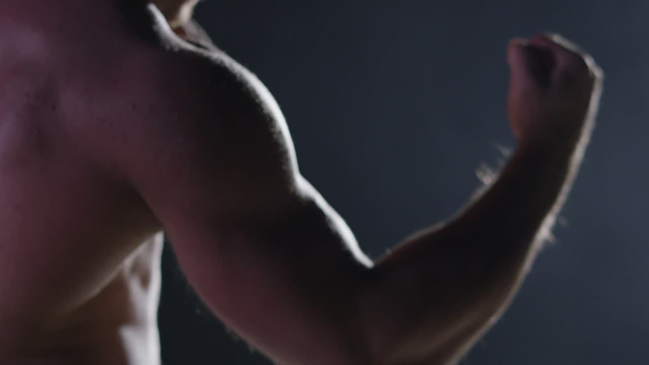 근육이 많은 남자가 이를 구부리고 있습니다.