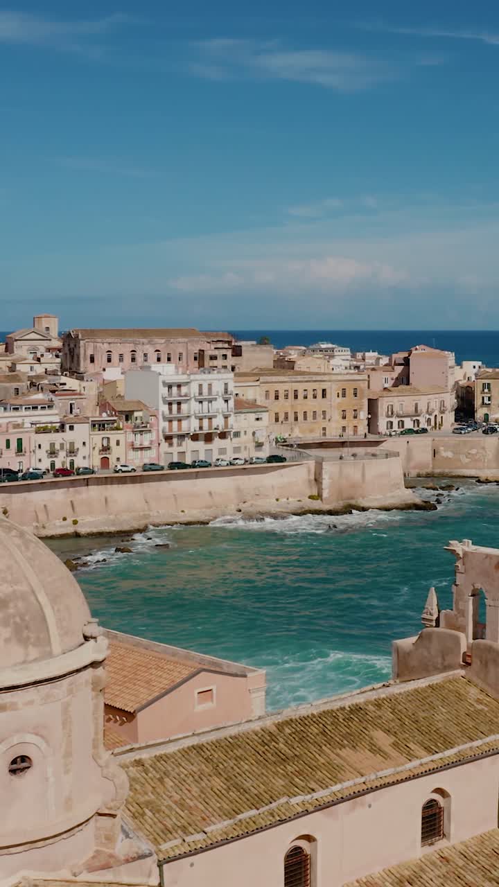 Vertical aerial view of cathedral tower in Ortigia island. Chiesa dello Spirito Santo. Historic old town by the Mediterranean sea in Syracuse. UNESCO world heritage site in Sicily.
