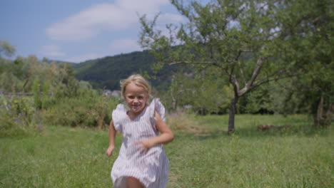 little girl running in a summer field