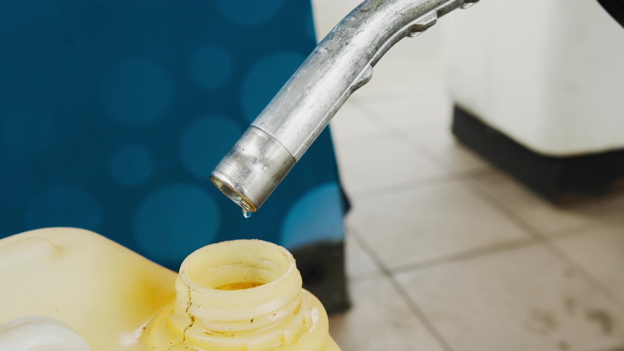 Petrol drips from the gas station pump