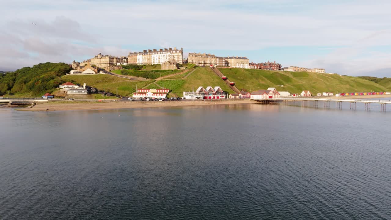 Aerial drone view of Saltburn-by-the-sea, Saltburn pier and ocean in Cleveland, North Yorkshire in summer, early morning