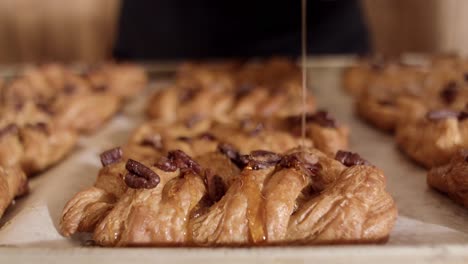 drizzling honey on pecan pastries