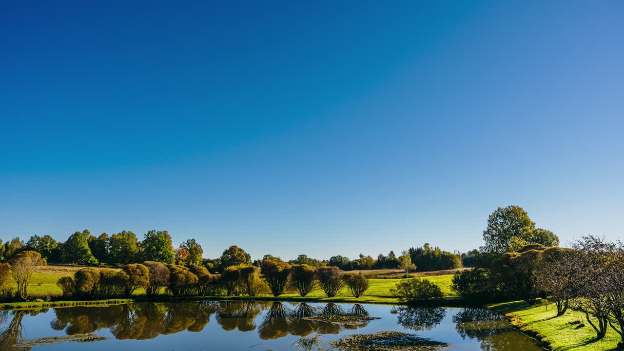 Morning sunrise timelapse with fog clearing out in verdant countryside landscape. Nature in Latvia at sunrise.
