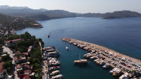 aerial high angle view of kas marina in antalya, turkey, with boats, blue waters, and lush hills surrounding the scenic harbor