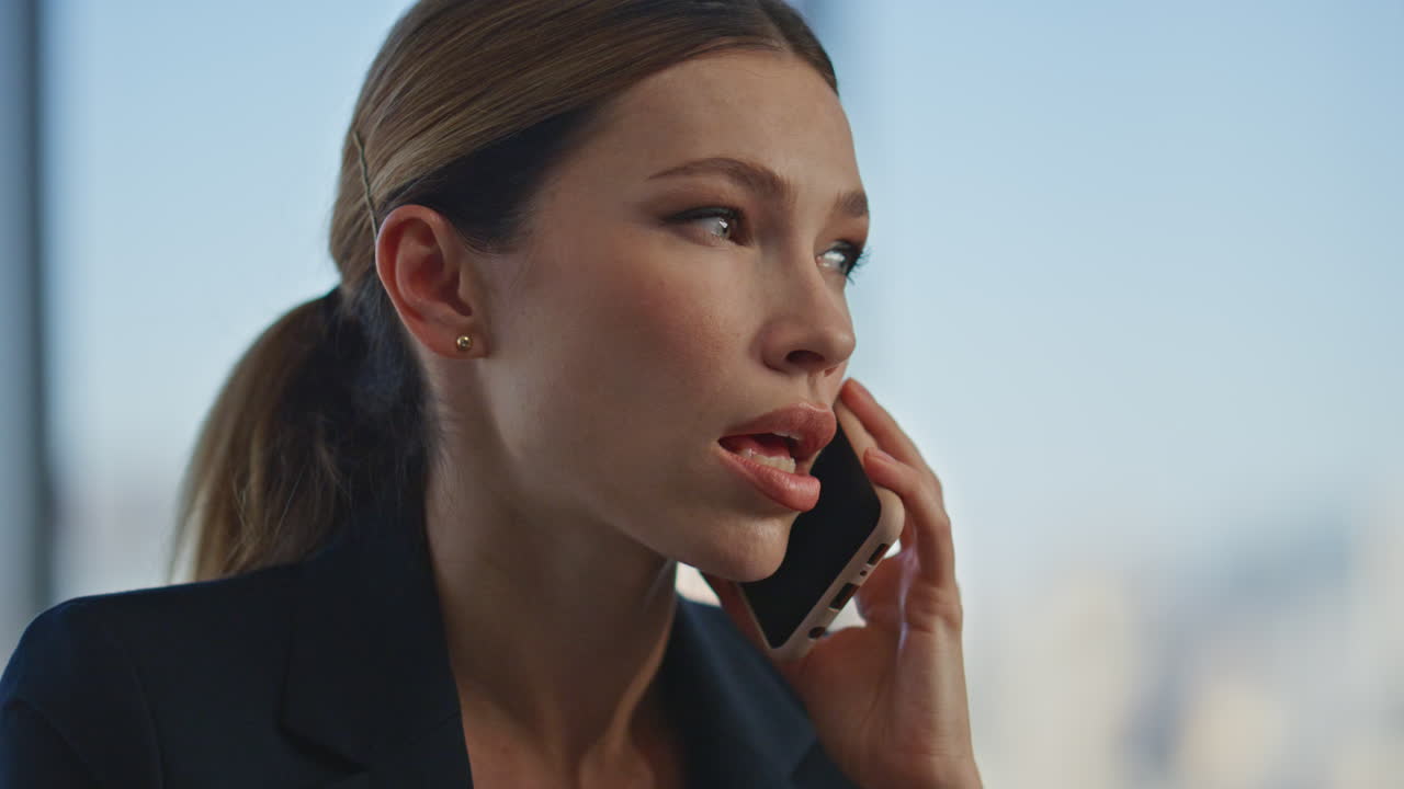 Serious worker speaking cell in office closeup. Professional woman manager talk