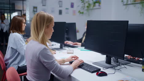 women working on a coding project in an office