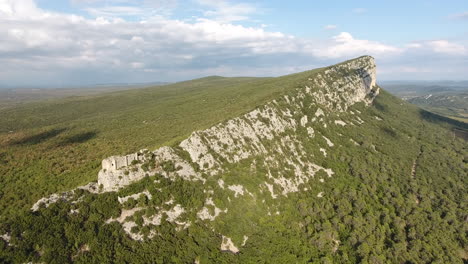 ruined castle on the edge of a cliff in south of france. pic saint loup mountain