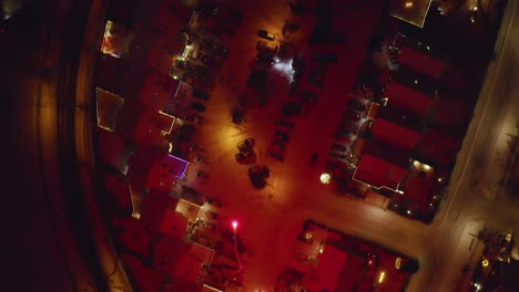 Fireworks Bursting In Snow-covered Neighborhood On New Year's Eve In Iceland. topdown drone shot