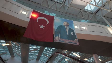 atatürk portrait and turkish flag hanging in airport