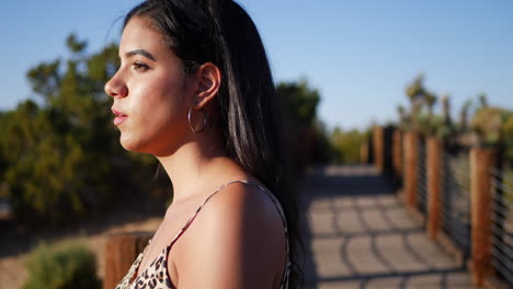 A-beautiful-hispanic-woman-traveler-watching-the-sunset-in-the-desert-SLOW-MOTION