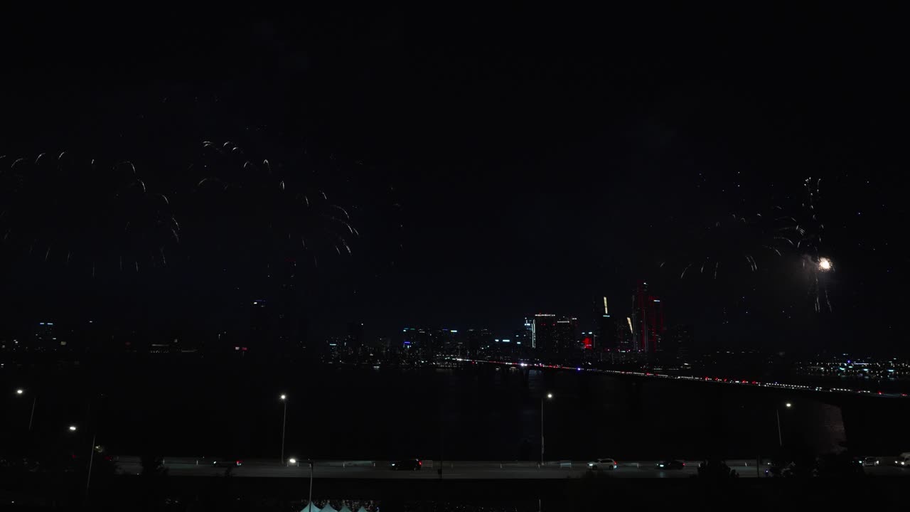 Spectacular Fireworks Display Over City River at Night