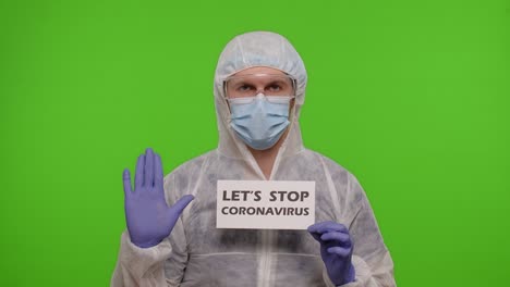 portrait of medical doctor in ppe suit with text inscription slogan on paper lets stop coronavirus