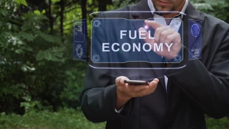 businessman uses hologram with text fuel economy