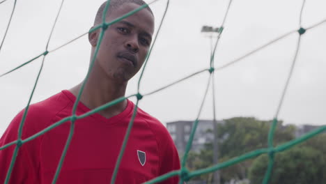 soccer player in front of goal net