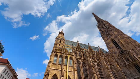 vienna, austria - june 9, 2025: tourists admire the magnificent st. tourists admire the magnificent st. stephen's cathedral in vienna under a bright blue sky and fluffy white clouds