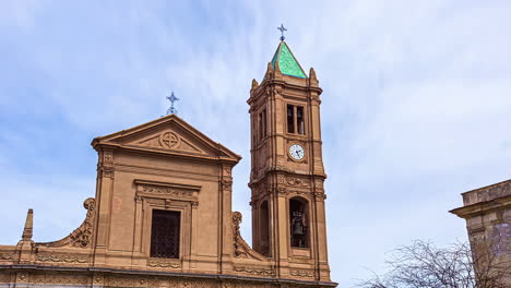 Static-view-of-a-church-tower-in-Caccamo,-beautiful-town-in-the-province-of-Palermo,-Sicily-with-cloud-movement-in-timelapse