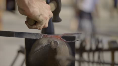 Slow-Motion-Shot-Of-Blacksmith-Working-On-Incandescent-Iron