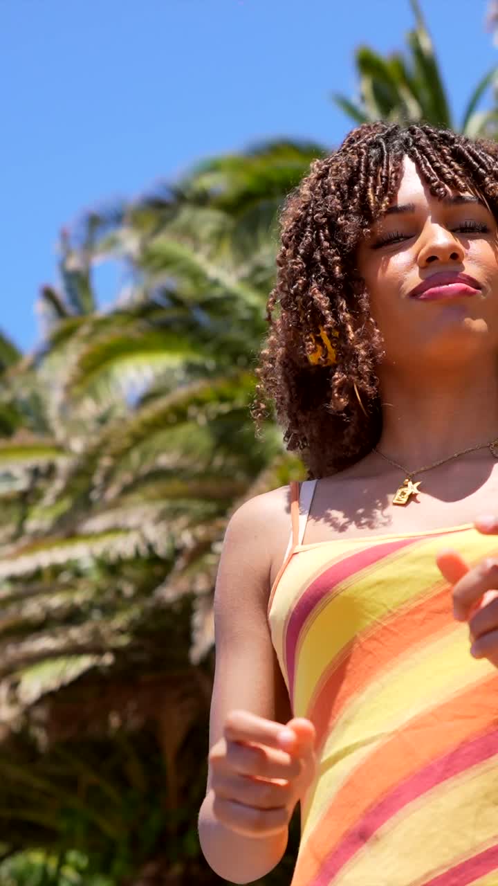 Portrait of a Woman with Curly Hair in a Striped Tank Top