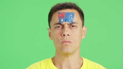 serious man with a australian flag painted on the face