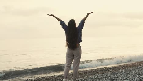 woman enjoying a peaceful sunrise on the beach