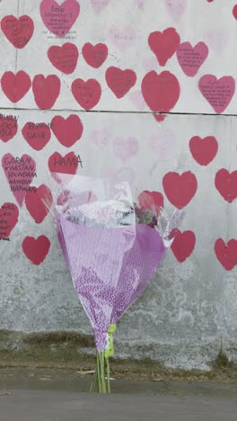 Vertical-Video-Of-The-National-Covid-Memorial-Wall-In-London-UK-With-Flowers