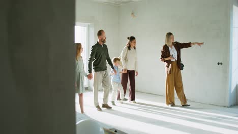 family touring a new house under construction