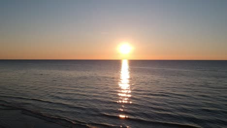 view of the sunset on clear sky over the baltic sea and beautiful sunbeam