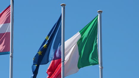 european and italian flags waving in the wind