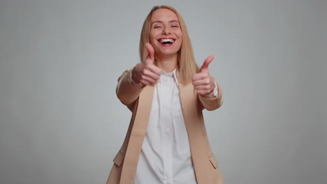 Woman raises thumbs up agrees or gives positive reply recommends advertisement likes good