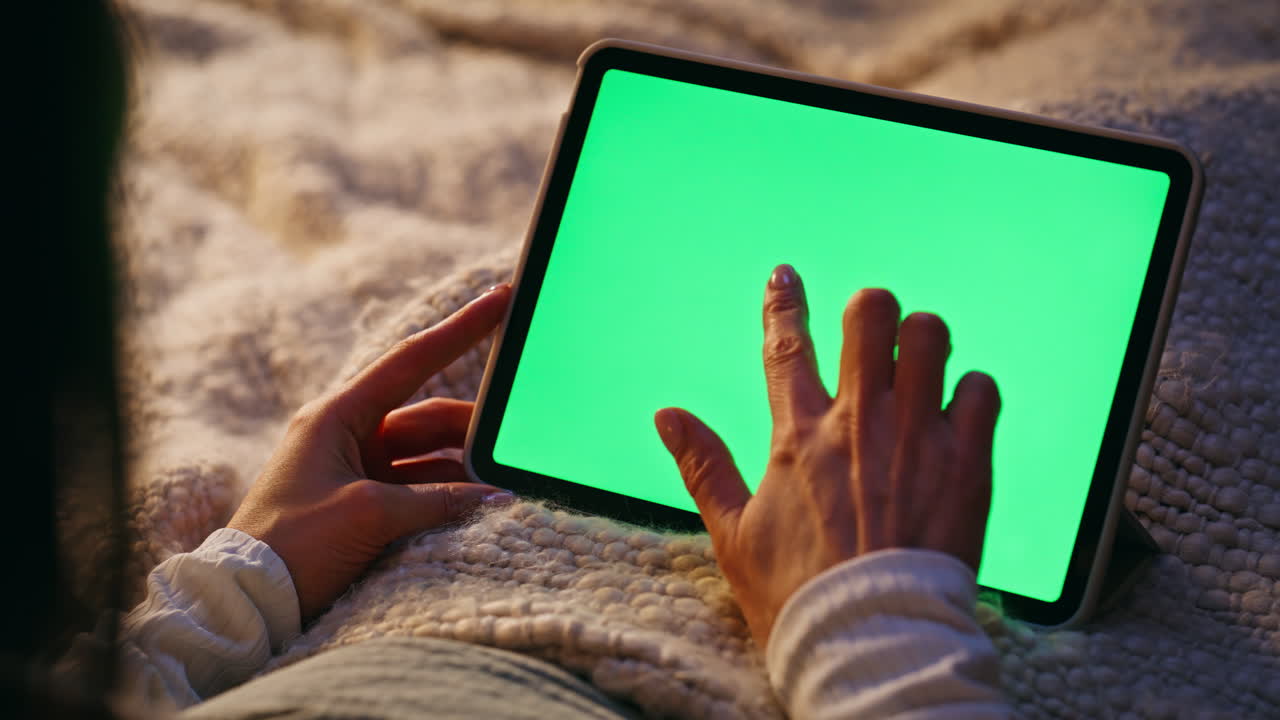 Finger tapping green screen tablet turning on online application closeup